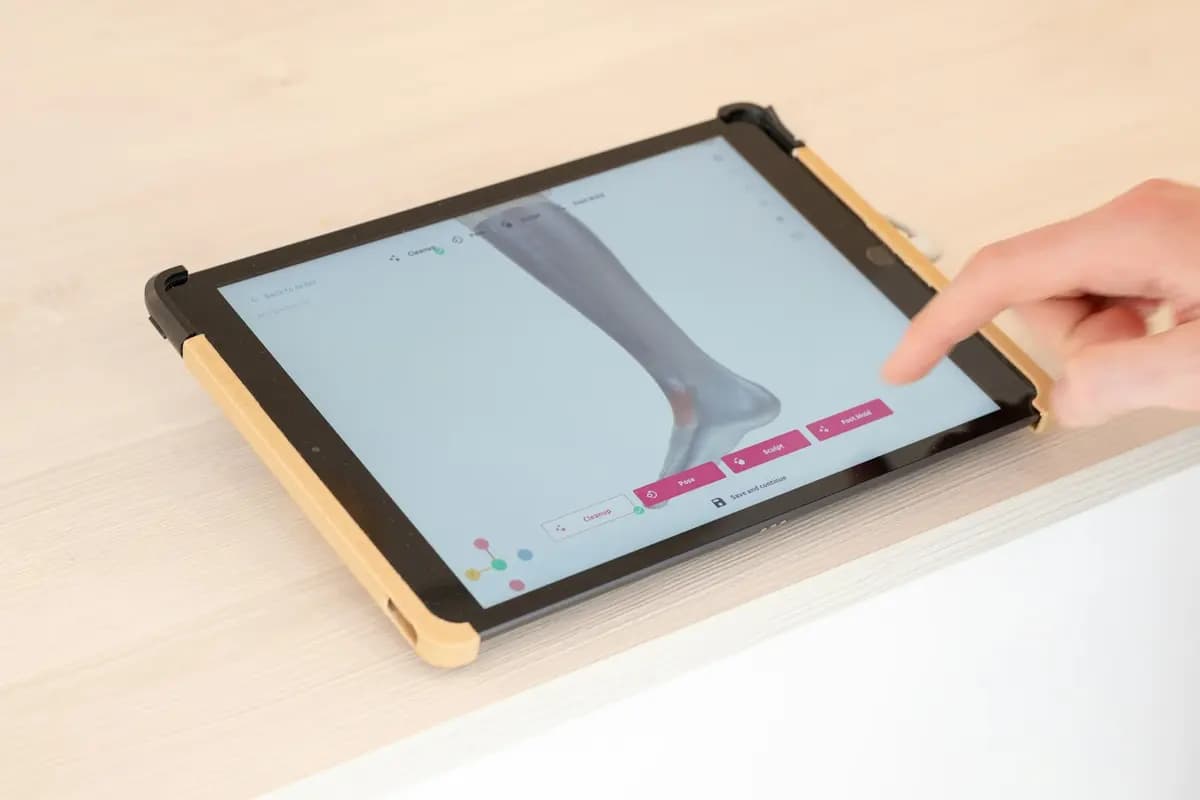 A finger turning a 3D model on a tablet screen