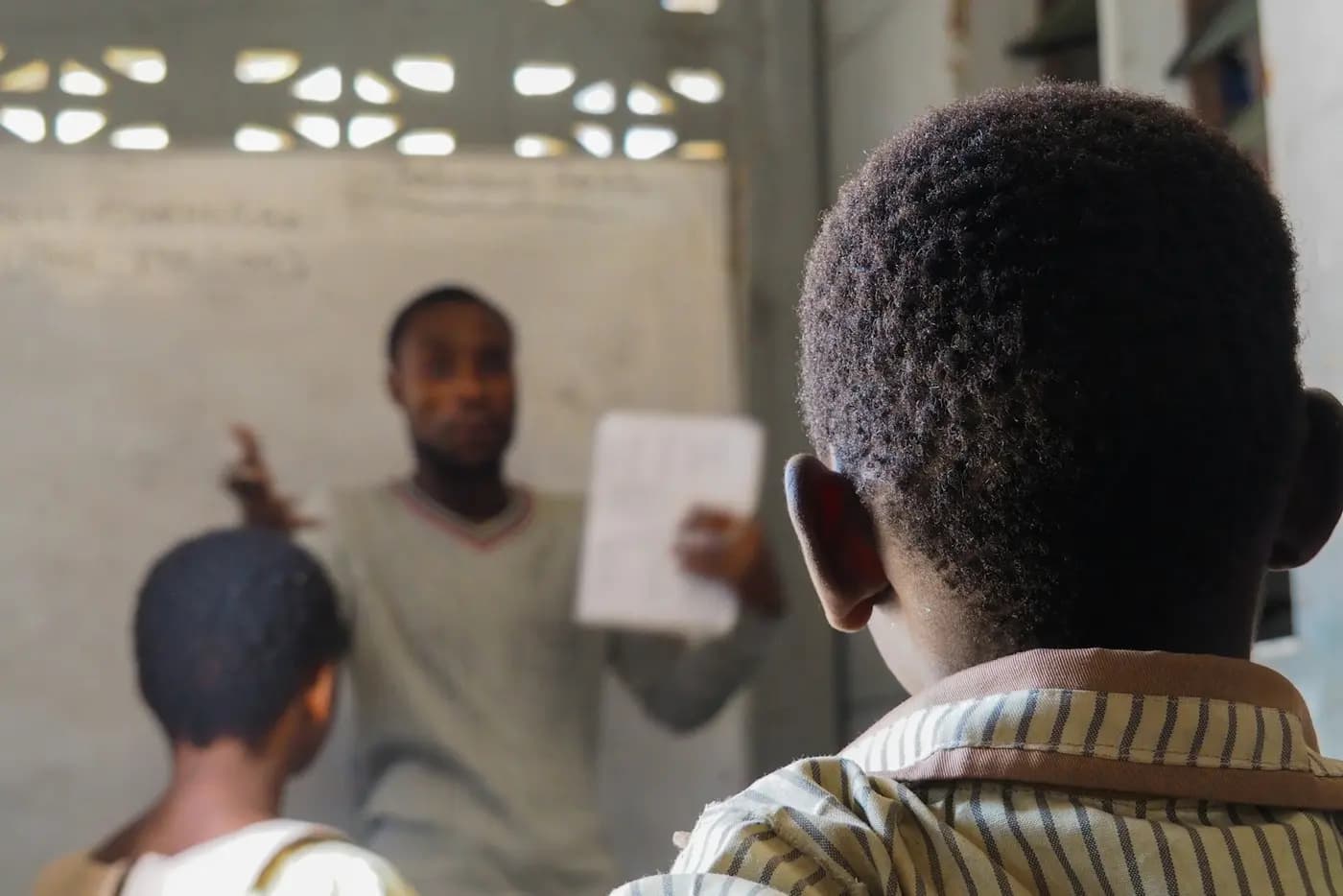 A teacher explaining a lesson to students in a classroom